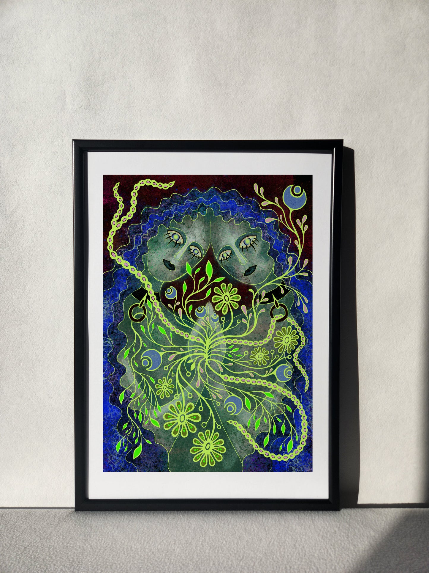 Romantic sapphic art print in black frame, featuring two girls in love surrounded by lush green florals and boho details, bathed in soft sunlight.