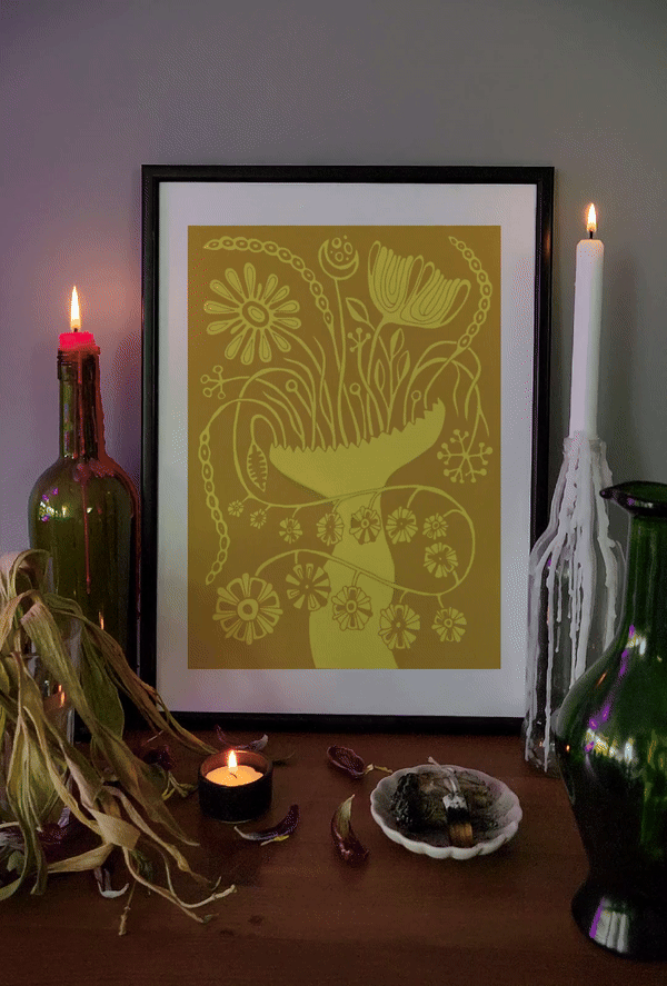 Yellow botanical art print in a black frame, styled on a candle-lit altar with dried herbs and vintage decor, evoking mystical folk aesthetics.