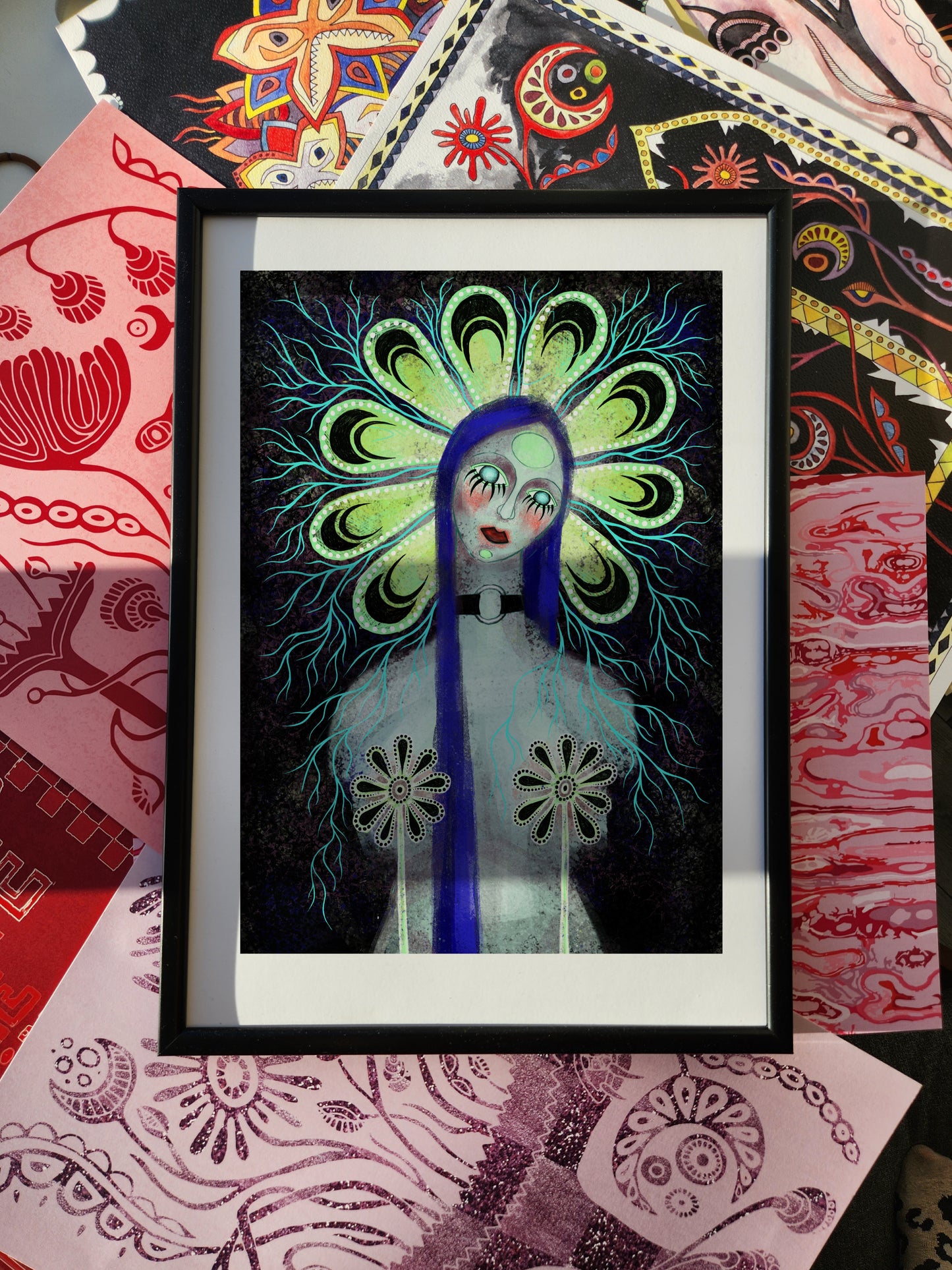 Female portrait poster and dark art print featuring a surreal woman with long blue hair, glowing floral halo, and symbolic flower motifs, framed for modern wall decor.